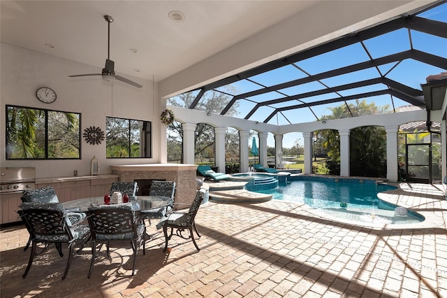 view of pool with glass enclosure, grilling area, ceiling fan, an in ground hot tub, and a patio area