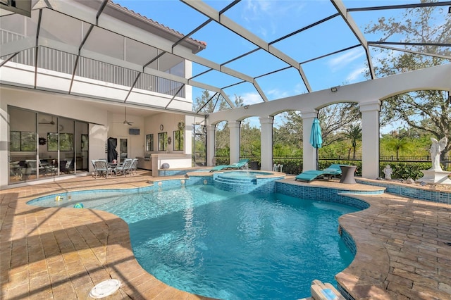 view of swimming pool with a lanai, a patio area, and an in ground hot tub