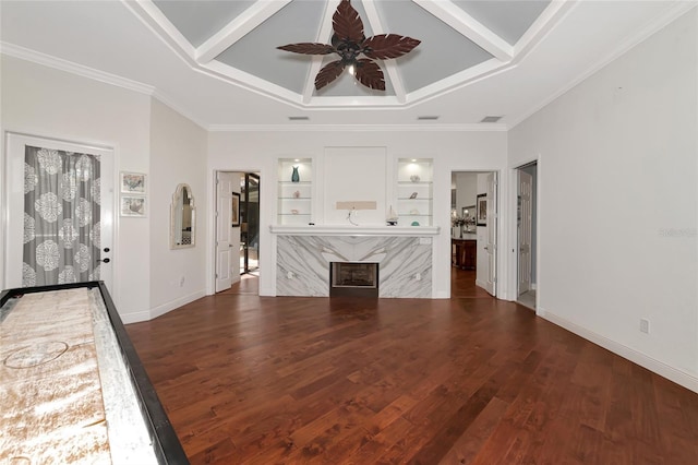 unfurnished living room featuring ceiling fan, crown molding, dark wood-type flooring, and a high end fireplace