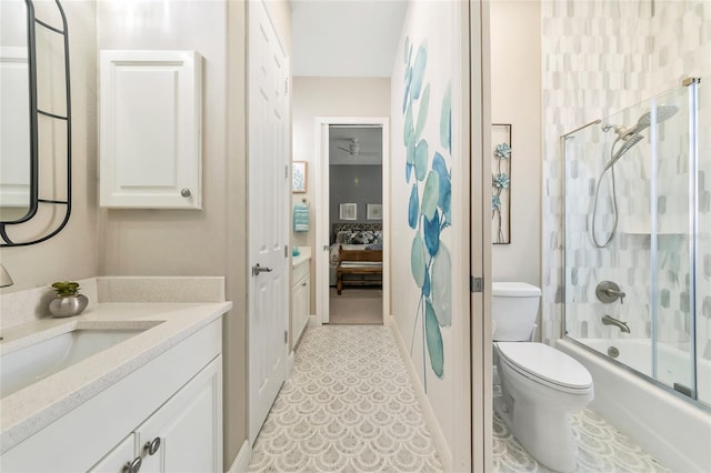 full bathroom featuring vanity, toilet, and bath / shower combo with glass door