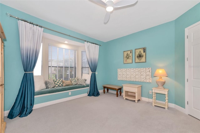 living area with ceiling fan and carpet floors