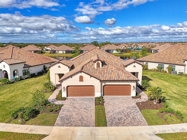 view of front of property with a garage and a front yard