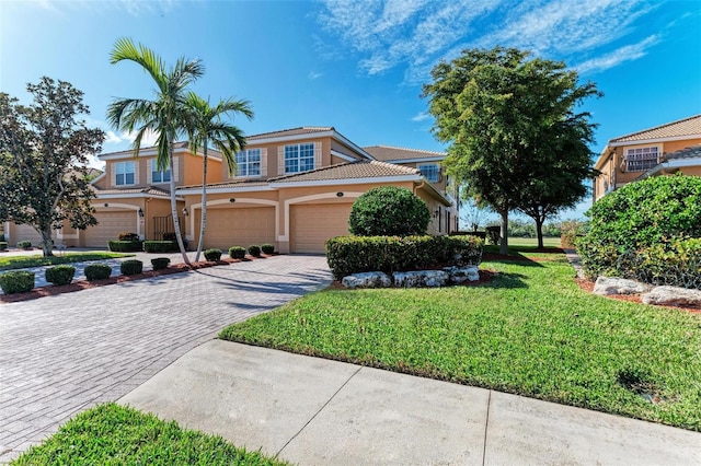 view of front of home with a front yard and a garage