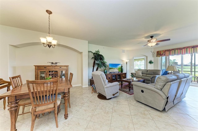 living room with ceiling fan with notable chandelier and light tile patterned flooring