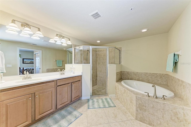 bathroom with tile patterned flooring, vanity, and plus walk in shower