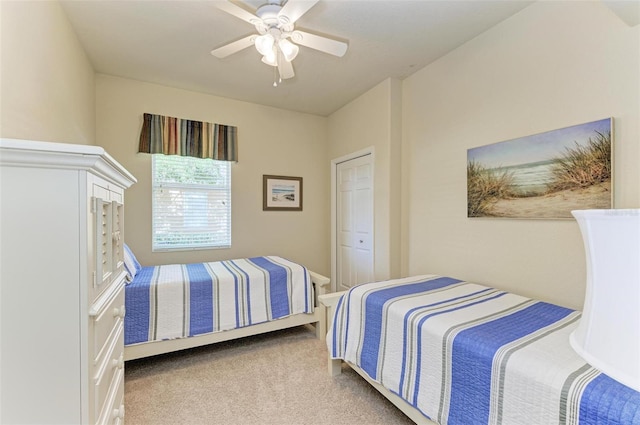 carpeted bedroom featuring a closet and ceiling fan