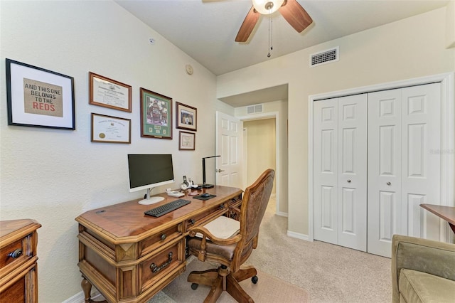 office space featuring ceiling fan and light colored carpet