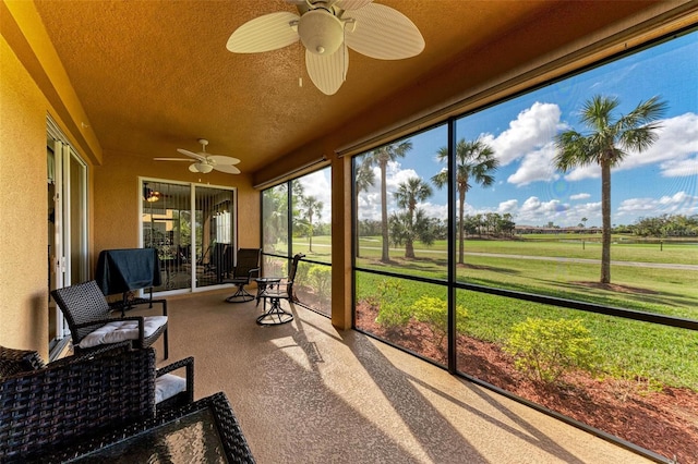 sunroom featuring ceiling fan