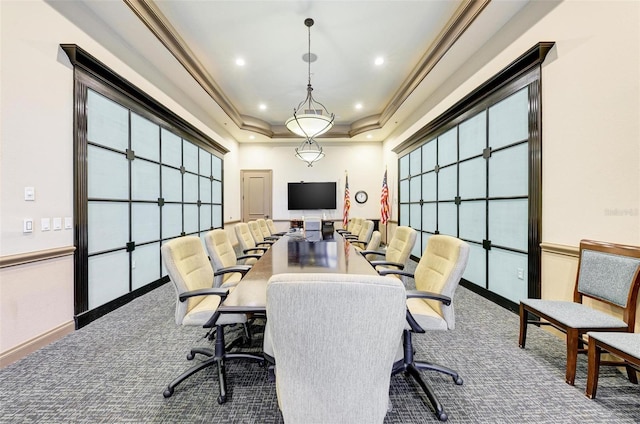 carpeted office space featuring a raised ceiling and crown molding