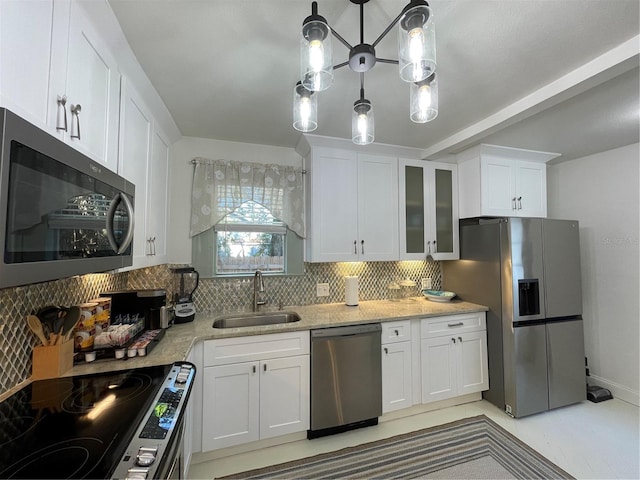 kitchen featuring white cabinets, decorative light fixtures, stainless steel appliances, and sink