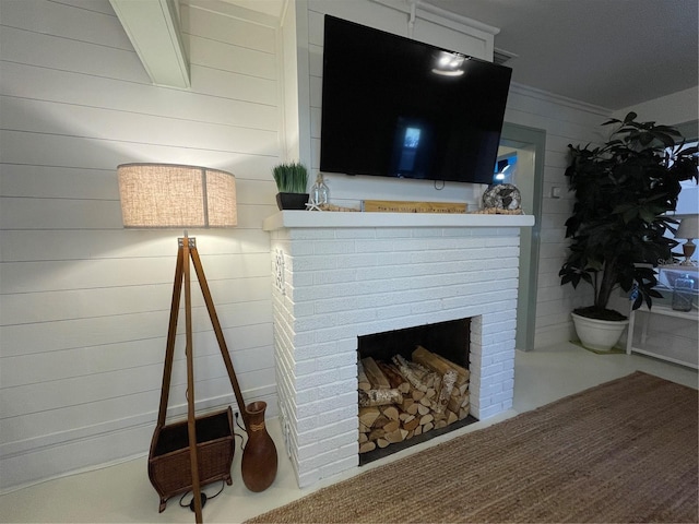 details with a fireplace, crown molding, and wood walls