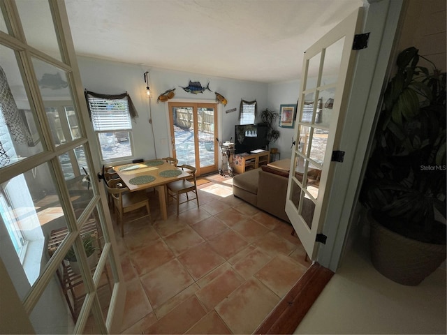 tiled dining room featuring french doors