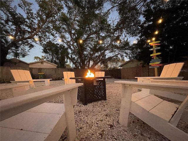 yard at dusk featuring a fire pit