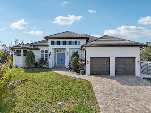 view of front of home featuring a front yard and a garage