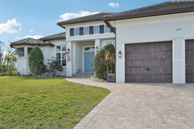 view of front of home with a front lawn and a garage