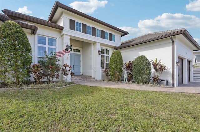 view of front of house with a front lawn and a garage