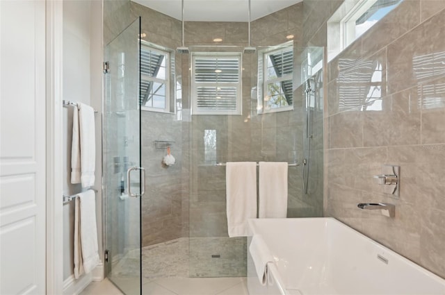 bathroom featuring tile patterned flooring and separate shower and tub