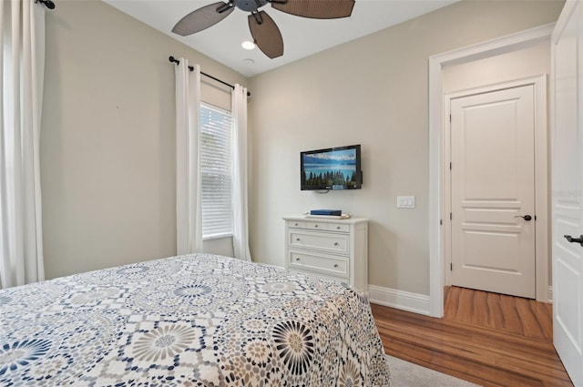 bedroom with ceiling fan and hardwood / wood-style flooring