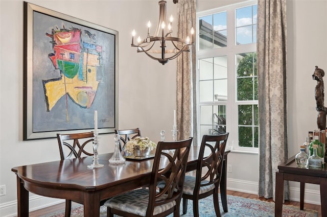 dining room with hardwood / wood-style flooring and a chandelier