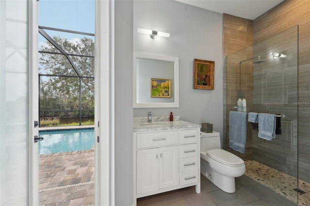 bathroom featuring an enclosed shower, vanity, tile patterned flooring, and toilet