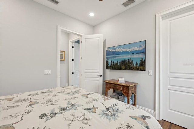 bedroom with dark hardwood / wood-style floors