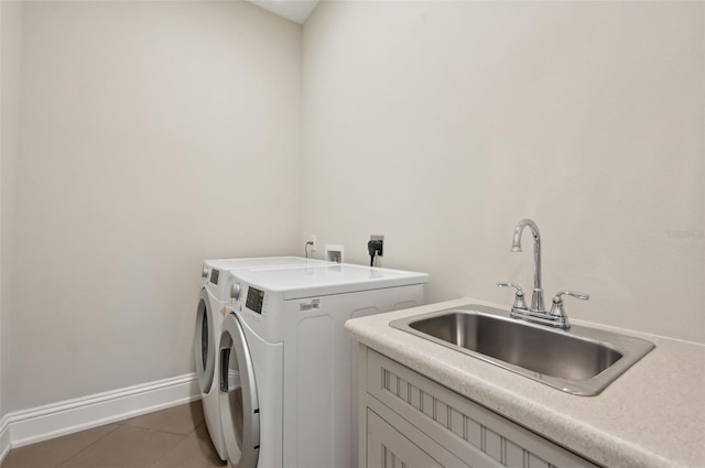 washroom featuring washing machine and dryer, cabinets, tile patterned flooring, and sink