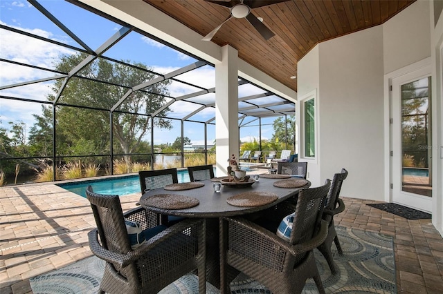 view of patio with glass enclosure and ceiling fan