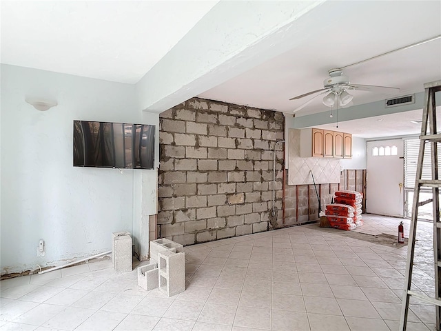 unfurnished living room with ceiling fan and light tile patterned floors