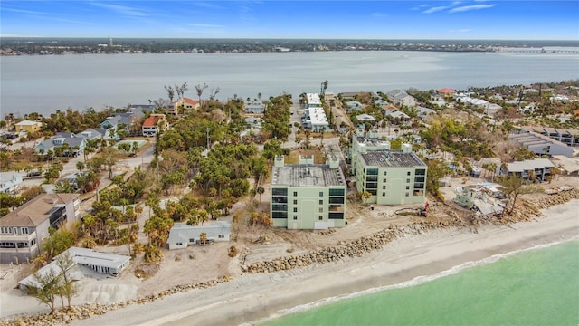 birds eye view of property featuring a water view and a view of the beach