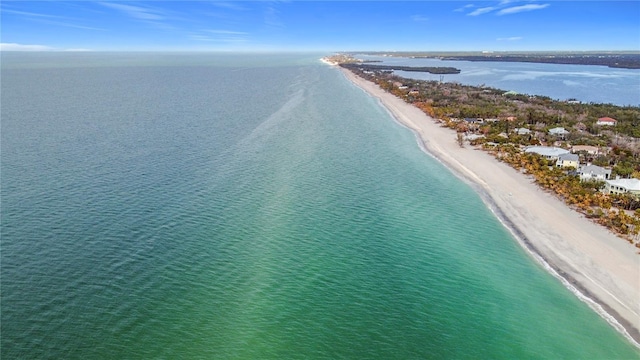 birds eye view of property featuring a water view and a beach view