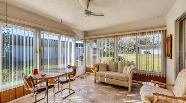 sunroom featuring ceiling fan