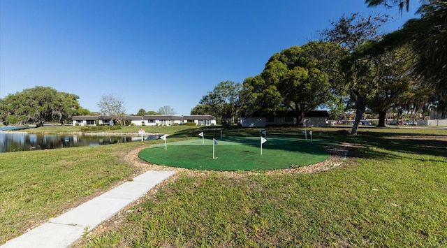 view of property's community with a lawn and a water view