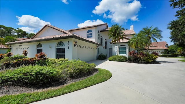 mediterranean / spanish-style home featuring a garage