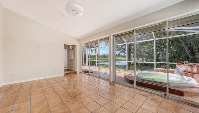 unfurnished sunroom featuring a water view and vaulted ceiling