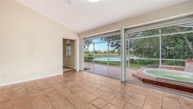 interior space with a water view and lofted ceiling