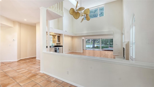 kitchen with a towering ceiling and light tile patterned floors