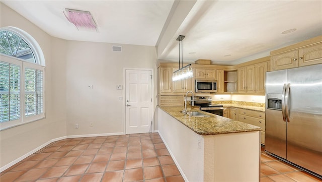 kitchen featuring kitchen peninsula, appliances with stainless steel finishes, light stone countertops, sink, and hanging light fixtures