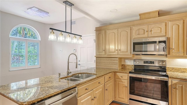 kitchen featuring hanging light fixtures, sink, stainless steel appliances, and light brown cabinets