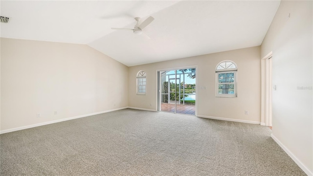 carpeted spare room with vaulted ceiling and ceiling fan