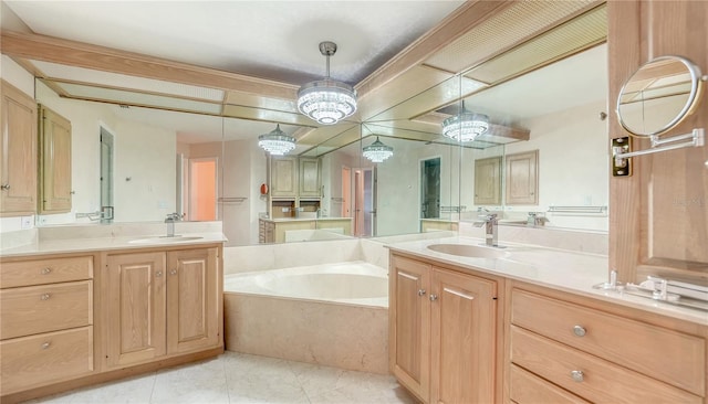 bathroom featuring a washtub, tile patterned floors, vanity, and an inviting chandelier