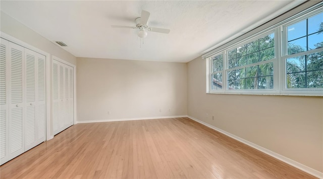 unfurnished bedroom with light wood-type flooring and ceiling fan