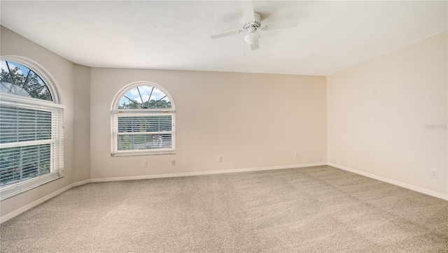 carpeted empty room featuring ceiling fan