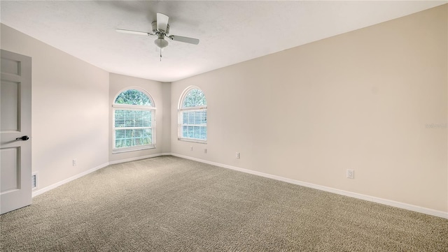 empty room with ceiling fan and carpet