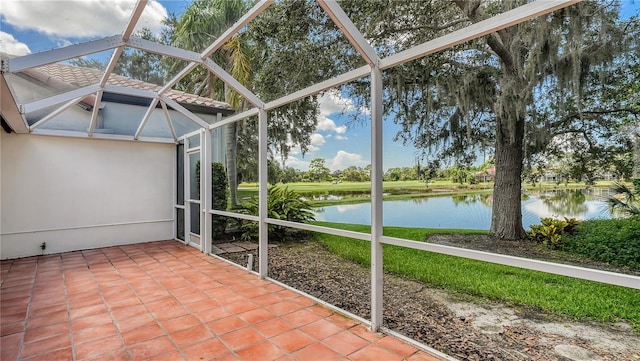 unfurnished sunroom featuring a water view