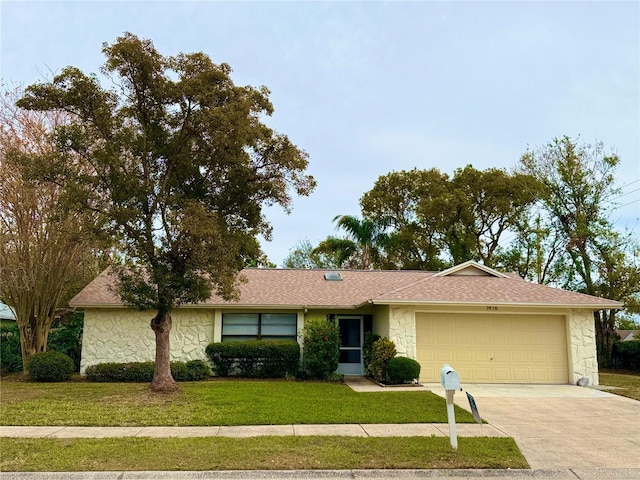 single story home with a front yard and a garage