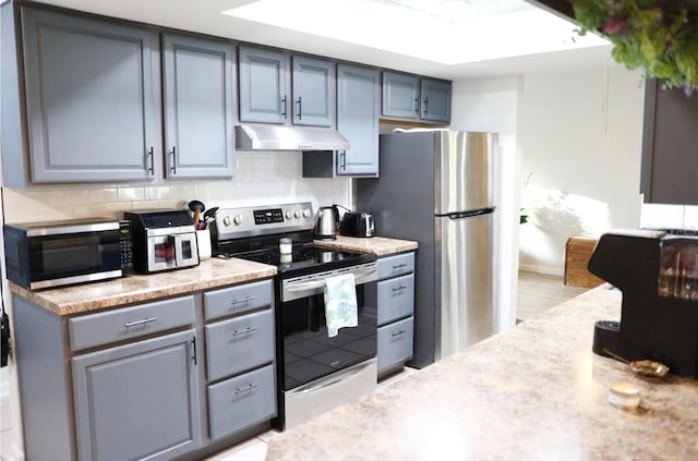 kitchen with tasteful backsplash and stainless steel appliances