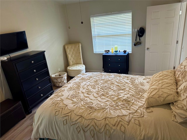 bedroom featuring wood finished floors