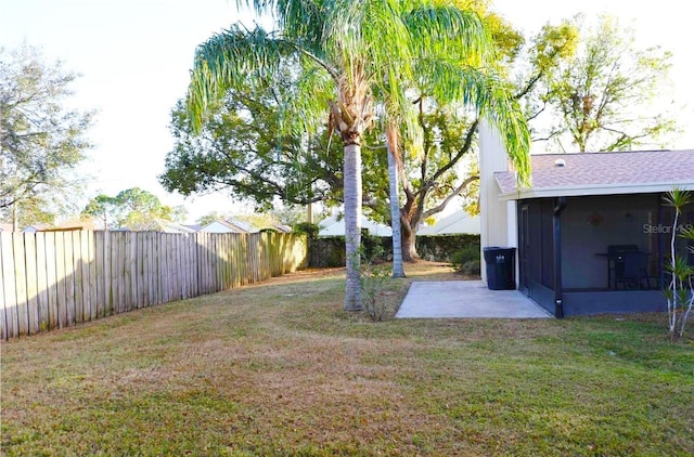 view of yard with a sunroom, a patio area, and a fenced backyard