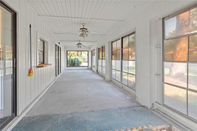 unfurnished sunroom featuring ceiling fan