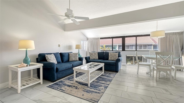 living room with a textured ceiling, ceiling fan, and lofted ceiling